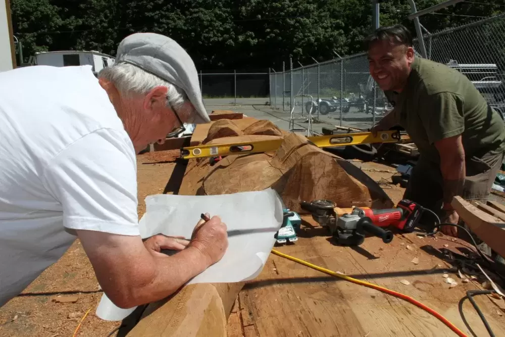 Peter Grant and Moy Sutherland Jr. rework a totem pole at Port Alberni's waterfront.