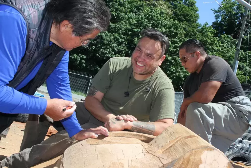 Tim Paul, Moy Sutherland Jr. and Guy Louie Jr. rework a totem pole at Port Alberni's waterfront.