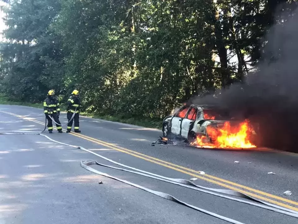 Firemen attend to a vehicle blaze on Franklin River Road on July 5. 