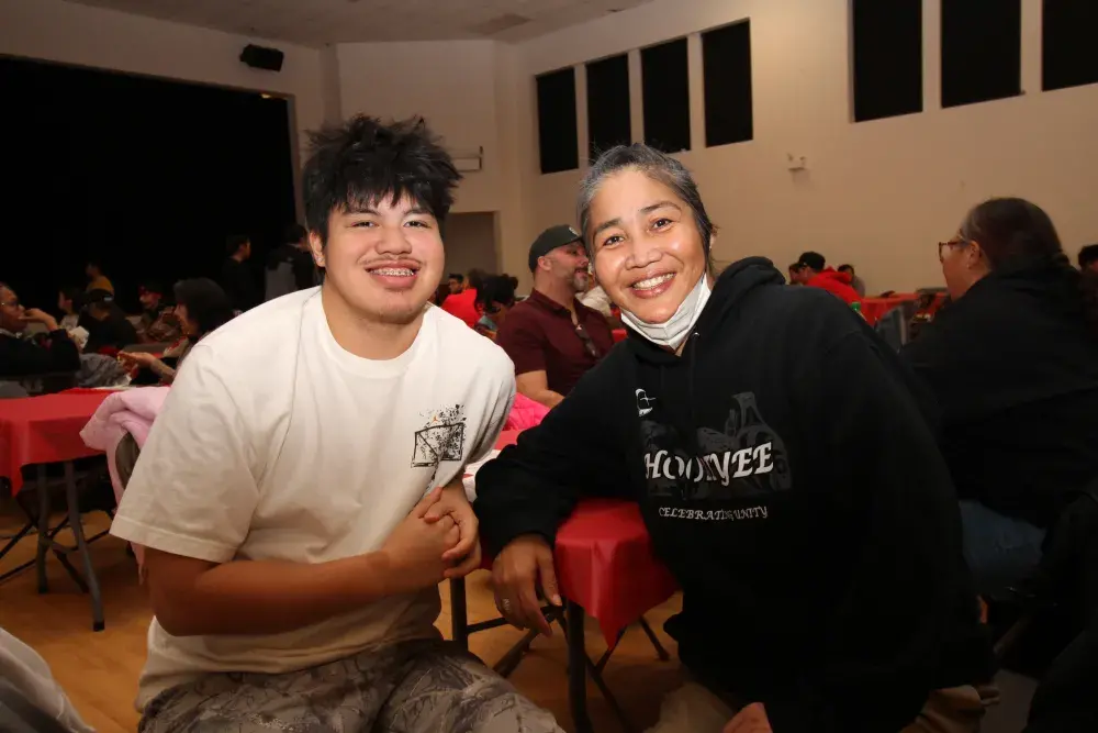 Huu-ay-aht's Keona Charles sits with Deb Cook.