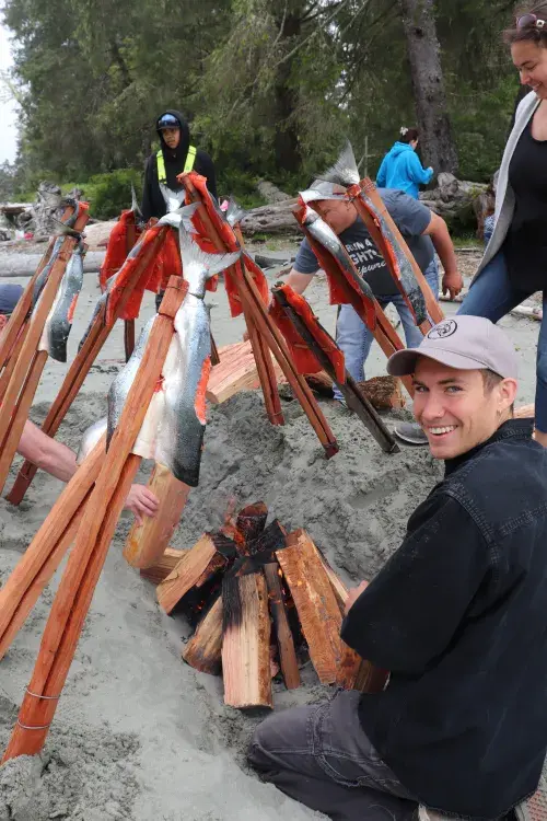 Carter Burtlake prepares a fire for a salmon barbecue.