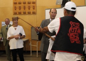 Artist presents a paddle to their Royal Highnesses, saying it's the only carving that I've ever finished.