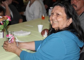 Residential School survivor Fran Tate receives flowers and love from the community