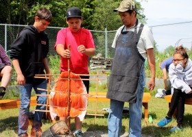 Joe teaches the kids how to place it in the ground