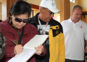 Signing the guest book for the 10th anniversary