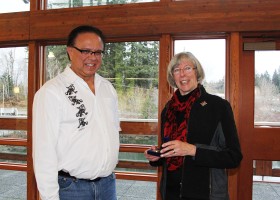 Chief Councillor Hugh Braker is presented a commemoration medallion by Judith Guichon, Lt-Gov.